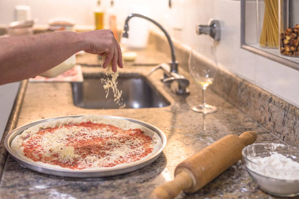 istock Homemade - Adding Mozzarella Topping to Pizza 1219405650