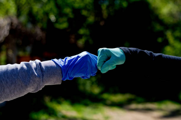 istock Two friends greeting during pandemic 1219405891