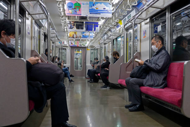 japanese people keep social distancing on the train. - urban scene commuter business station imagens e fotografias de stock