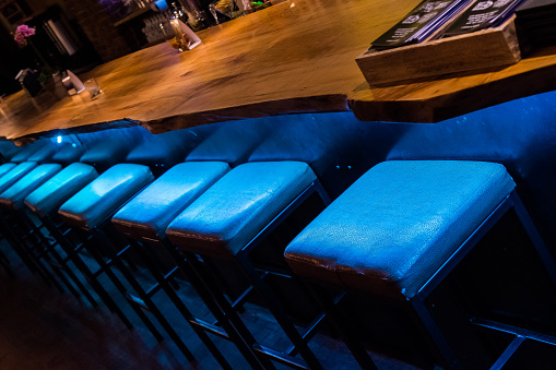 Blue Bar Stools lined up at a Bar