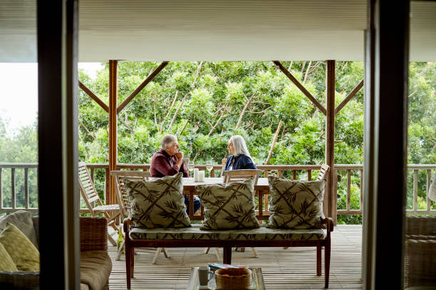 istock Mature couple enjoying wine in balcony 1219407475