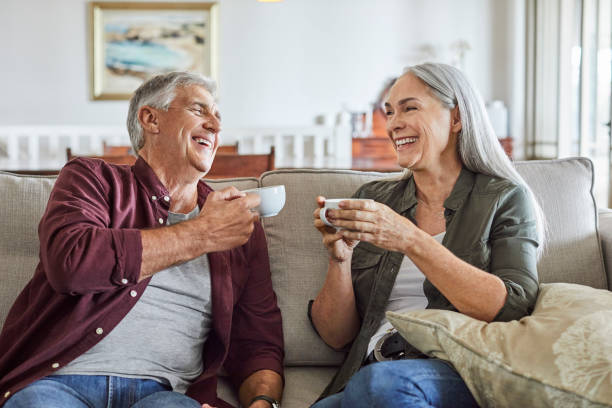 happy mature couple drinking coffee at home - senior adult cheerful adventure discovery imagens e fotografias de stock