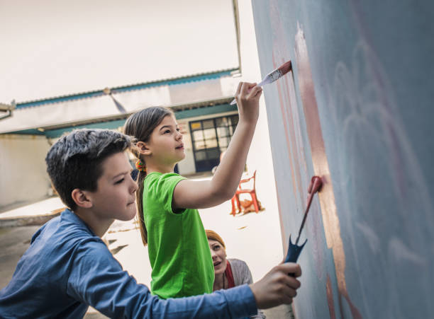 istock Two children draw paints  on a wall 1219409540