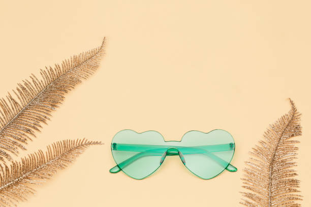 istock Creative top view with modern sunglasses on paper background. Heart shaped eyeglasses pastel colored. Minimal summer concept. Flat lay with copy space. 1219410290