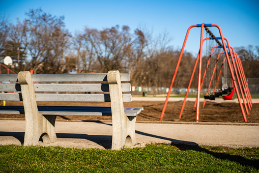 Park Bench with Swings in the Background