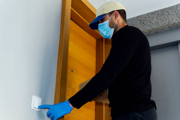 istock delivery man delivering package during quarantine for coronavirus 1219411687