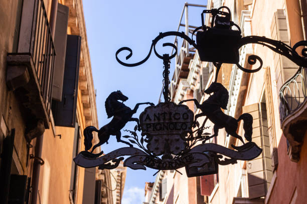 Sign of Antico Pignolo restaurant on C. de la Rizza street in Venice Venice, Italy, September 28, 2015 : Sign of Antico Pignolo restaurant on C. de la Rizza street in Venice palazzo antico stock pictures, royalty-free photos & images