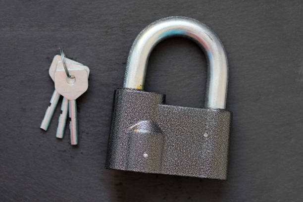 istock A padlock with a thick handle and three steel keys. 1219413523