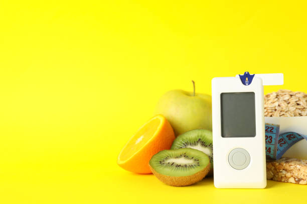 istock Blood glucose meter and diabetic food on yellow background 1219414914