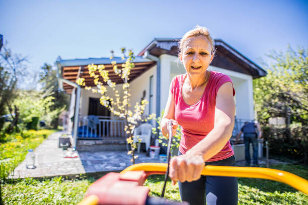 istock Women  mows  the grass while pandemic 1219414925