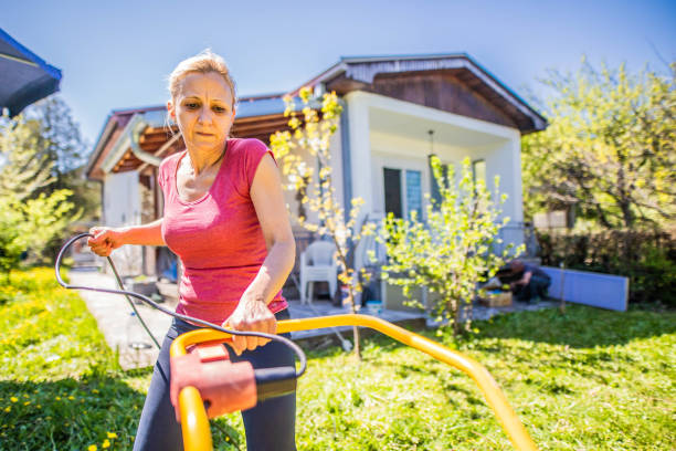 istock Women  mows  the grass while pandemic 1219414966