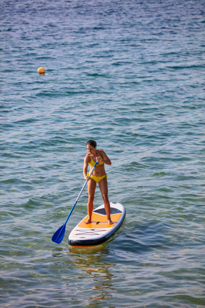 istock Woman on a paddleboard 1219415269