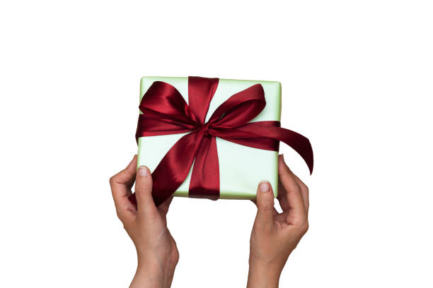 istock Woman holding a christmas gift isolated on white background 1219416146