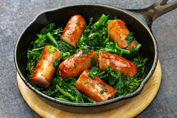 salsiccia e cime di rapa, sausage and braised tunip greens salsiccia e cime di rapa, sausage and braised tunip greens in skillet, southern italian cuisine brassica rapa stock pictures, royalty-free photos & images