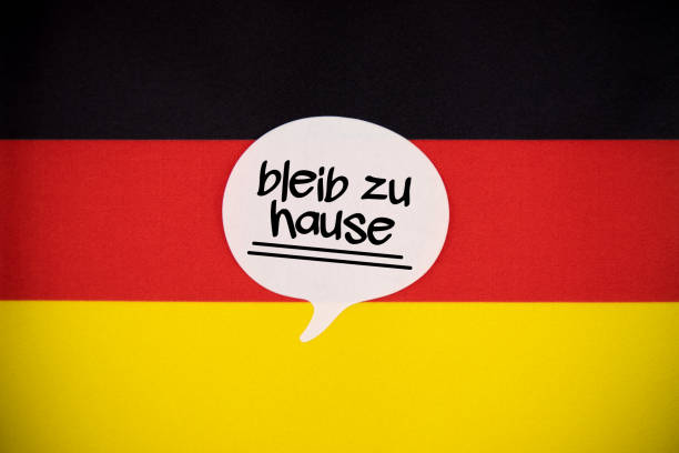 istock White Speech Bubble Note Paper With Stay Home Message in German Language On The German Flag. 1219416340