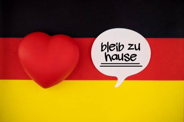 istock White Speech Bubble Note Paper With Stay Home Message in German Language On The German Flag 1219416365