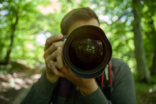 istock photographer holds the camera in his hands 1219417291