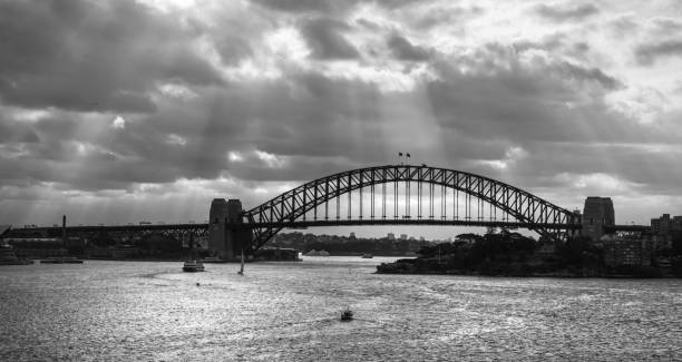 istock Panoramic view of the Sydney Harbour Bridge under a dramatic day, black and white 1219417486