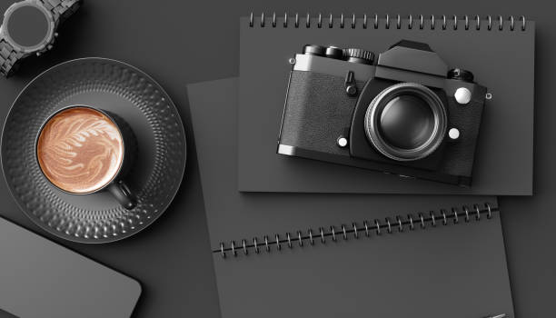 istock cup of coffee next to the camera on a black background 1219417918