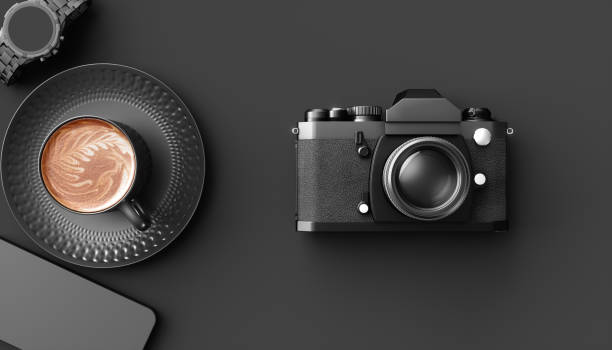 istock cup of coffee next to the camera on a black background 1219417949