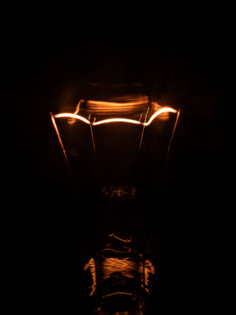 istock macro detail of light bulb with dark background 1219419124