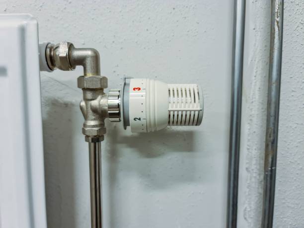 istock Close up view of heating element controller on white wall background. Industry concept. 1219419148