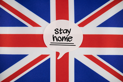 White Speech Bubble Note Paper With Stay Home Message On The UK Flag. Horizontal composition with copy space.