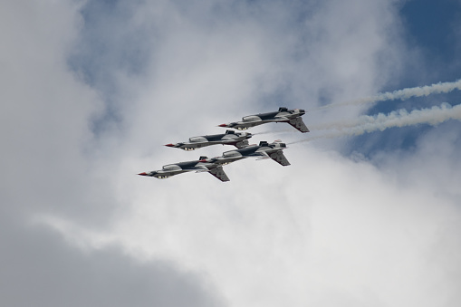 Four USAF Thunderbirds perform loop over Colorado Air Force Academy as feature of Graduation of cadets. At Colorado Springs, Colorado