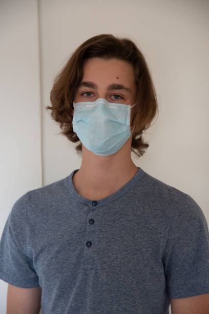 istock Medical mask worn on a young man 1219420677