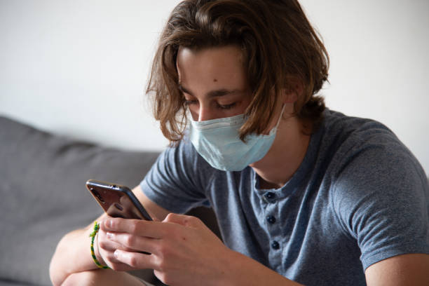 istock Medical mask worn on a young man 1219420793