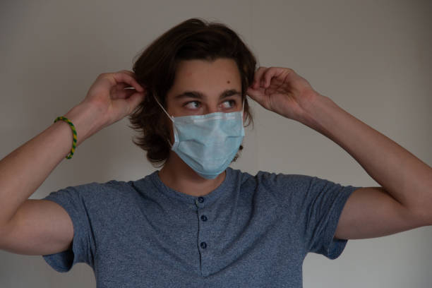 istock Medical mask worn on a young man 1219420831