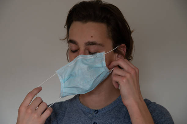 istock Medical mask worn on a young man 1219420900