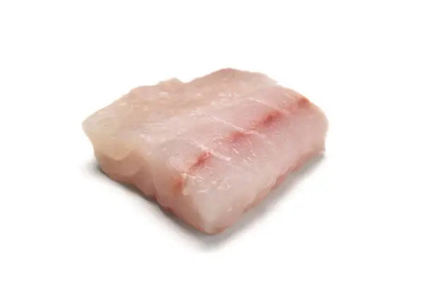 A raw fresh grouper fish filet isolated on white background.