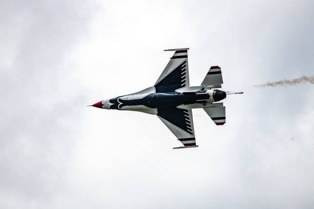 Single thunderbird showing underside. USAF Thunderbirds perform over Colorado Air Force Academy as feature of Graduation of cadets.