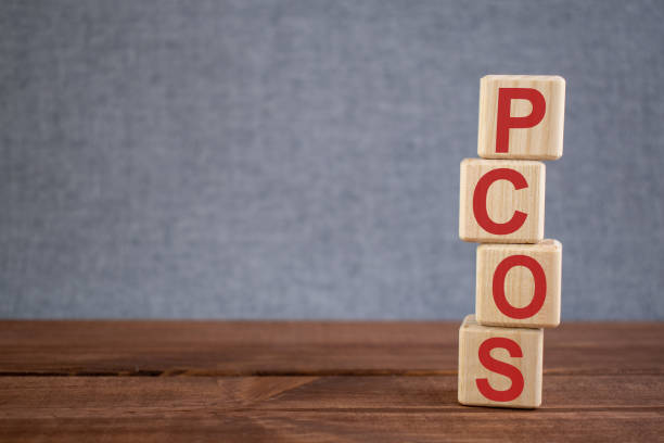 Abbreviation PCOS (polycystic ovarian syndrome) text acronym on wooden cubes on dark wooden backround. Medicine concept. Abbreviation PCOS (polycystic ovarian syndrome) text acronym on wooden cubes on dark wooden backround. Medicine concept. polycystic ovary syndrome photos stock pictures, royalty-free photos & images