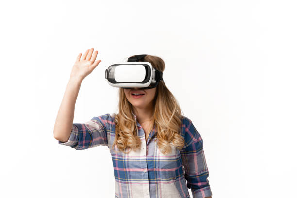 istock Emotional caucasian woman using VR-headsed isolated on white studio background, technologies. Greeting 1219424555