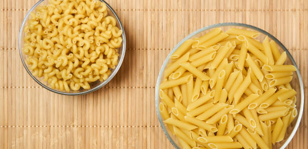istock two bowls of dried pasta on a cane tablecloth 1219427312