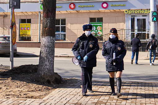 Perm, Russia - April 15, 2020: street police patrol monitors self-isolation during the COVID-19 epidemic in Perm, Russia