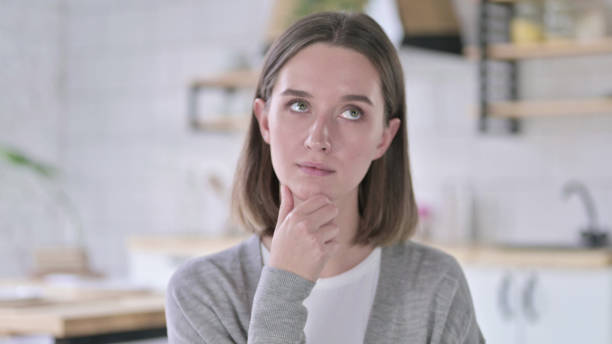 istock Portrait of Young Woman Thinking about Creative Idea 1219428204