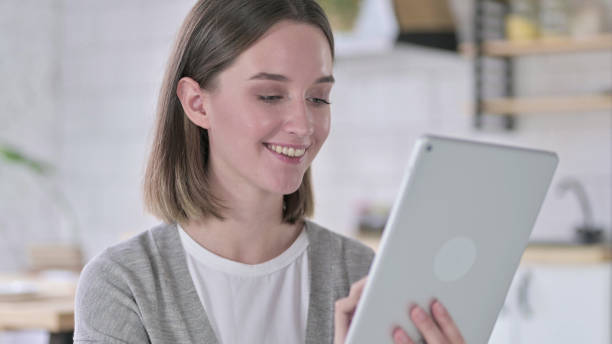 istock Portrait of Young Woman using Tablet in Modern Office 1219428308