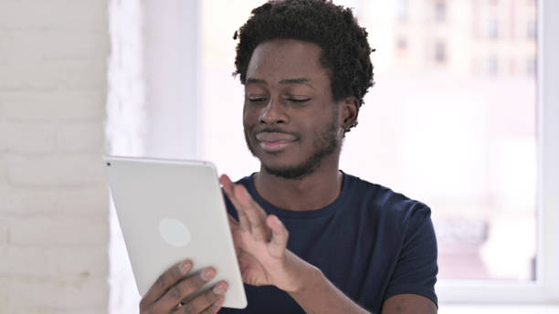 istock Portrait of Young African American Man Using Tablet 1219428309