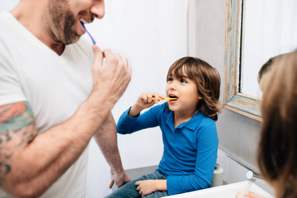 istock Father daughter and son brushing teeth 1219428722