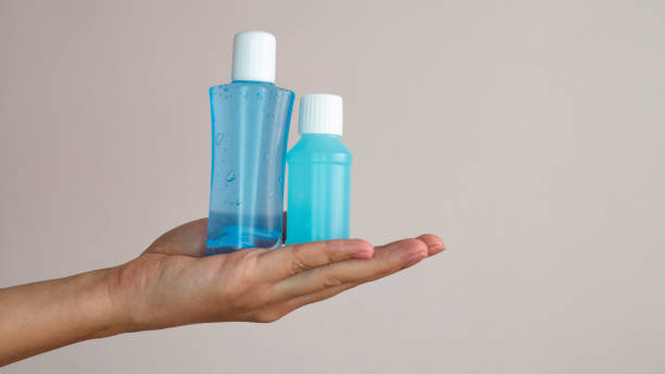 istock Two plastic bottles of hand sanitizer in a woman's hand. Negative space. 1219428821