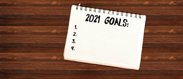 istock 2021 goals text on notebook on wood table. Business motivation, inspiration concept. 1219428918