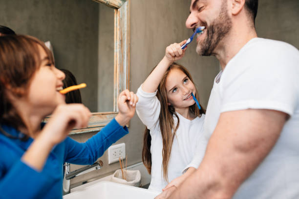 istock Father daughter and son brushing teeth 1219429970