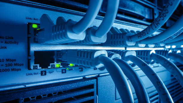 istock Close-up Macro Shot: Ethernet Cables Connected to Router Ports with Blinking Lights. Telecommunications RJ45 Device Connectors Plugged into Modem Hubs. Secure Data Center. 1219430124