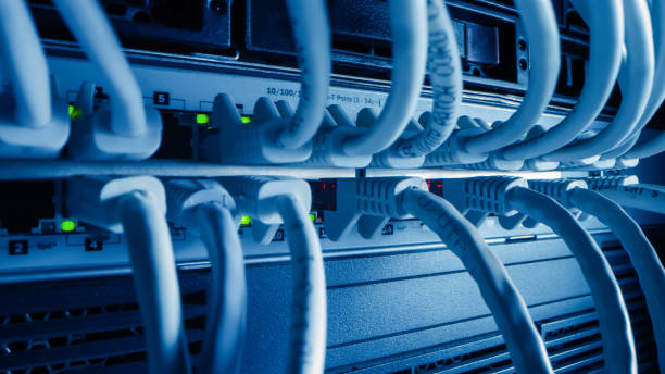istock Close-up Macro Shot Ethernet Cables Connected to Router Ports with Blinking Lights. Telecommunications: RJ45 Device Connectors Plugged into Modem Hubs. Secure Data Center. 1219430142