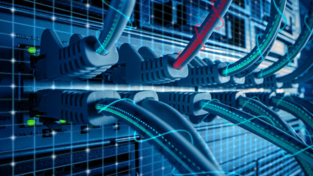 istock Macro Shot with Augmented Reality: Ethernet Cables Connected to Router Ports with Virtual Graphichs Showing Data Transfer. Telecommunications: RJ45 Internet Connectors Plugged into Modem LAN Switches. 1219430158