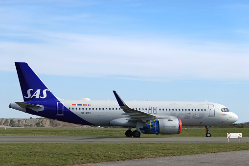 Multiple grounded SAS Scandinavian Airlines airplanes parked on the runway in Copenhagen, Denmark. Worldwide the airline industry has been taking a hard financially hit due to the Covid - 19, Corona Virus Pandemic.