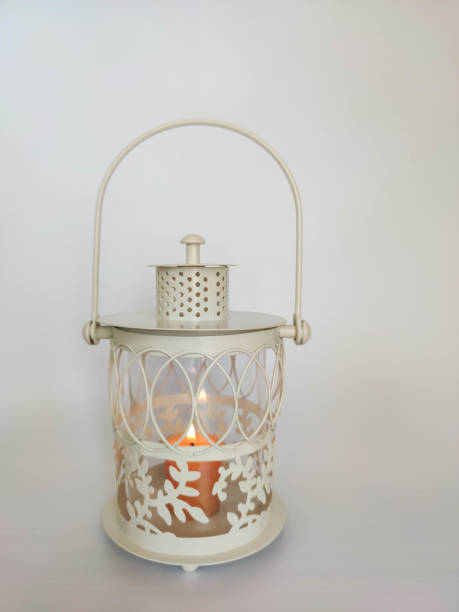 istock Vintage lantern with an orange candle on the table with white background. Concept - Ramadan kareem holiday celebration. Royalty Free Stock photo 1219431119